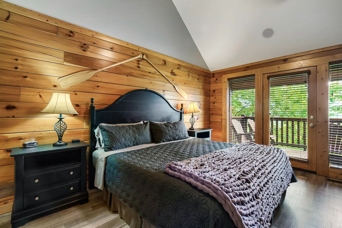 Bedroom with stained glass window and log walls